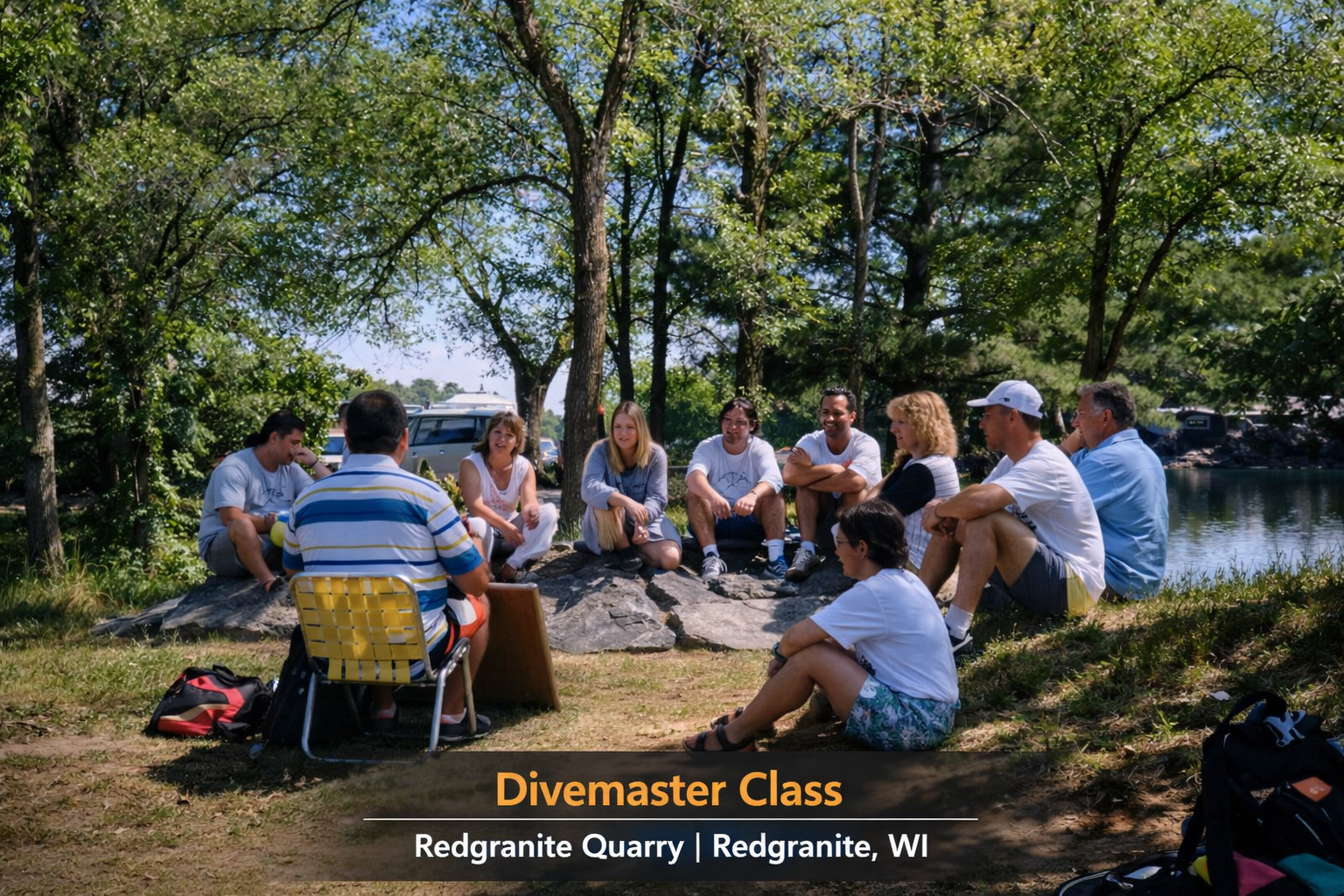 A group of scuba diving students and their instructor gathered in a circle outdoors for a Divemaster class at Redgranite Quarry in Wisconsin.