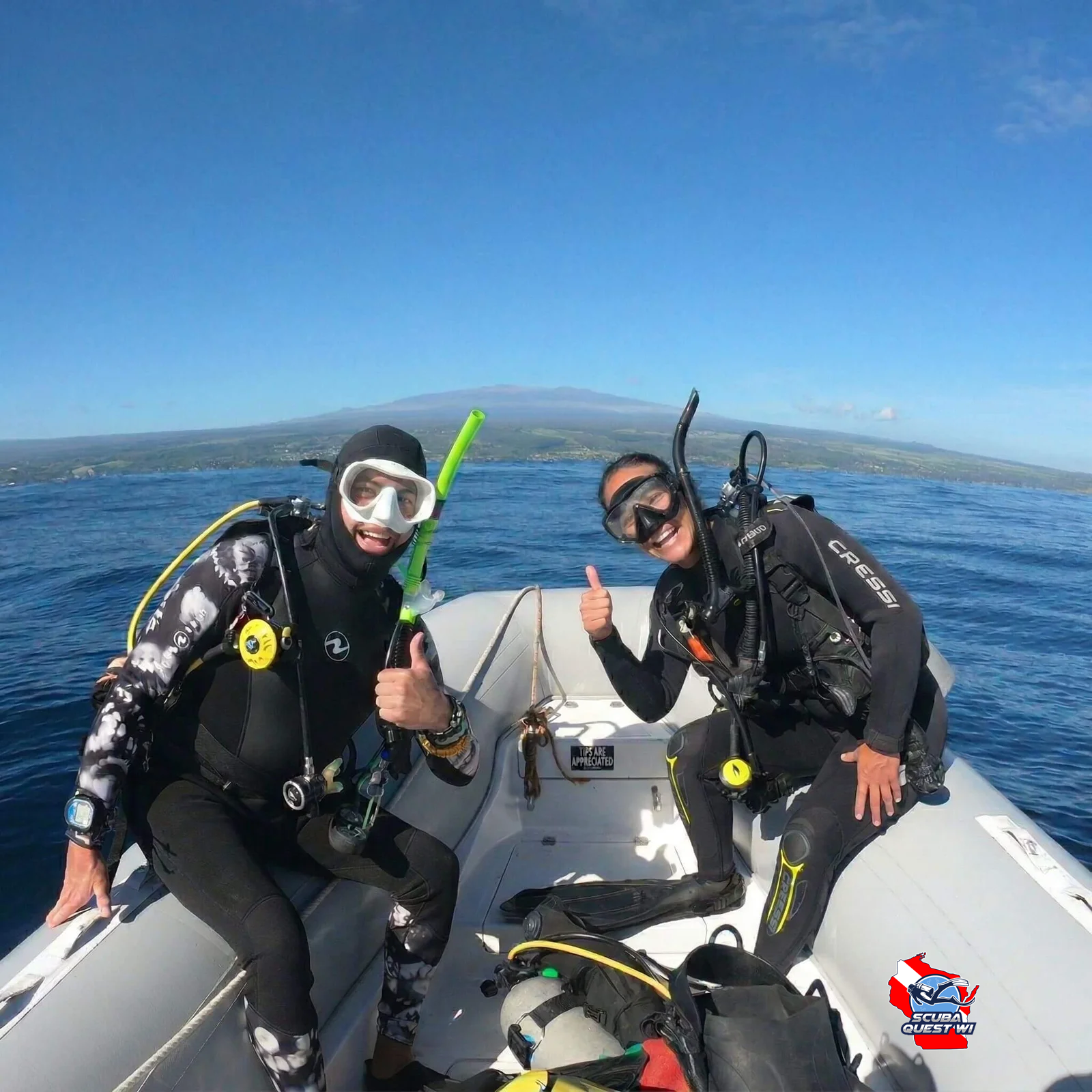A group of scuba diving students in full gear preparing to enter the ocean from a dive boat.